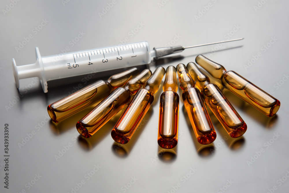medical ampoules for injection and syringe. medicines and disease treatment. pharmacology and science medical ampoules for injection and syringe. medicines and disease treatment. pharmacology and science