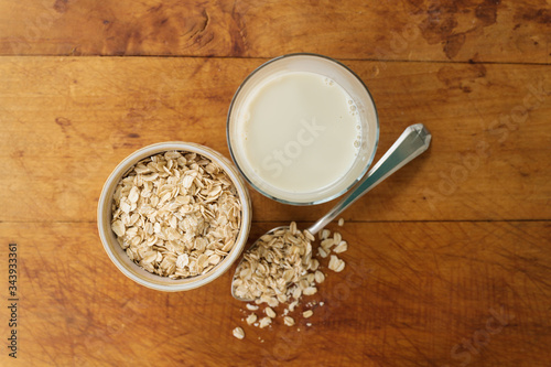 Oats and oat milk against wood photo