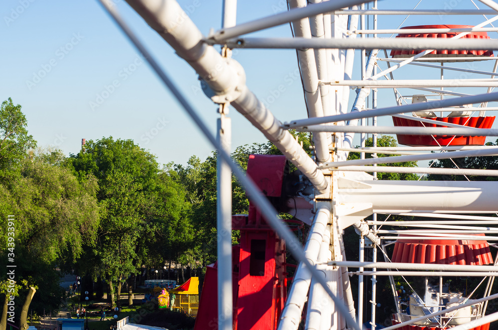 Attractions in spring city Park - Ferris Wheel Over Blue Sky Attractions in spring city Park - Ferris Wheel Over Blue Sky