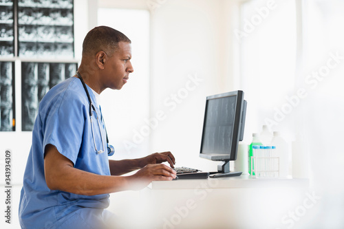 Male doctor in hospital using digital tablet photo