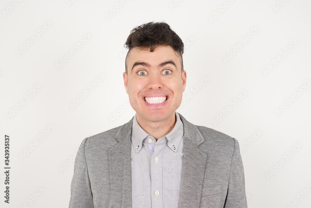 Young handsome man having broad white smile being excited to meet Friends and go out to have a good day. Young handsome man having broad white smile being excited to meet Friends and go out to have a good day.