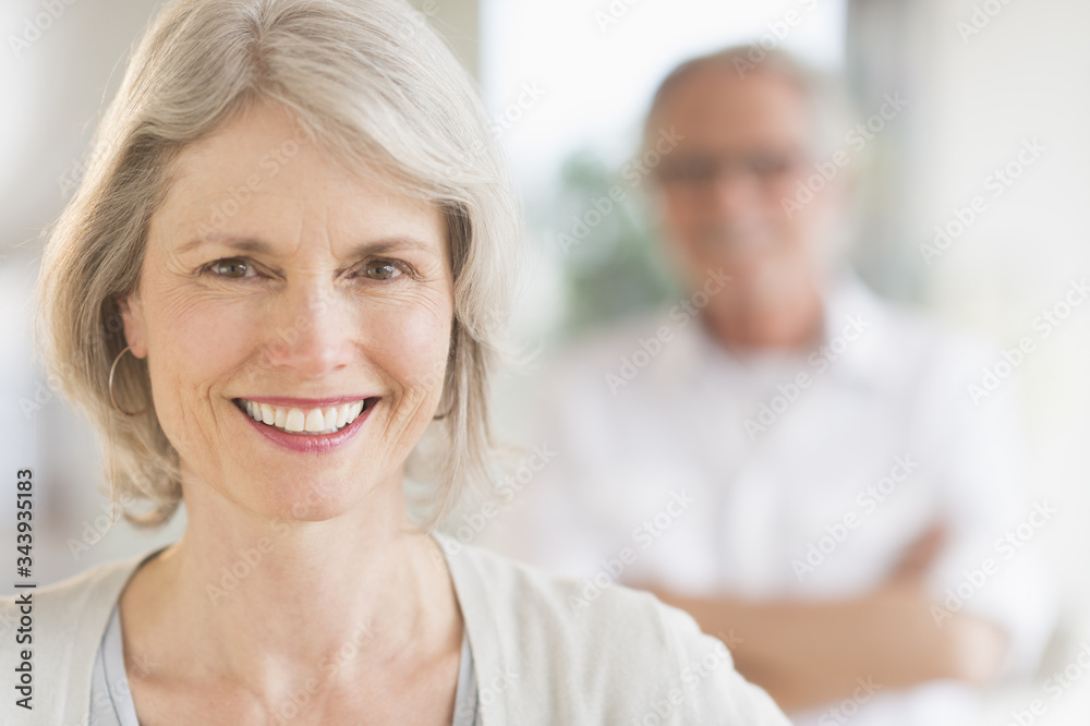 Portrait of senior woman, man in background Portrait of senior woman, man in background