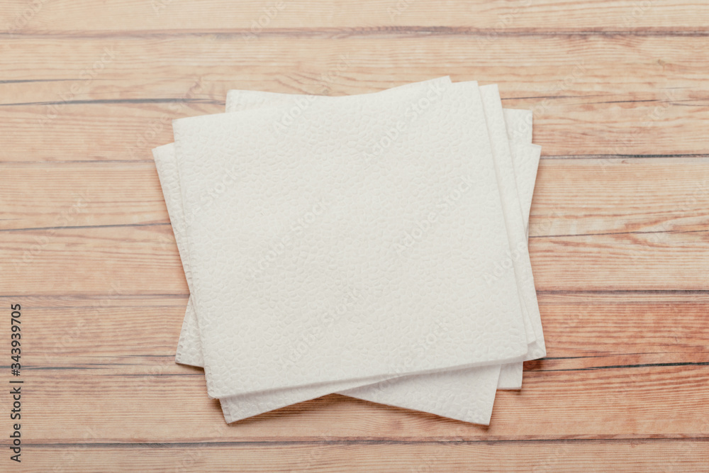 white paper napkin with a textured pattern on an old table white paper napkin with a textured pattern on an old table