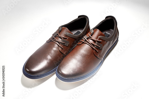 Men fashion brown shoe leather over white background. Pair casual stylish footwear.