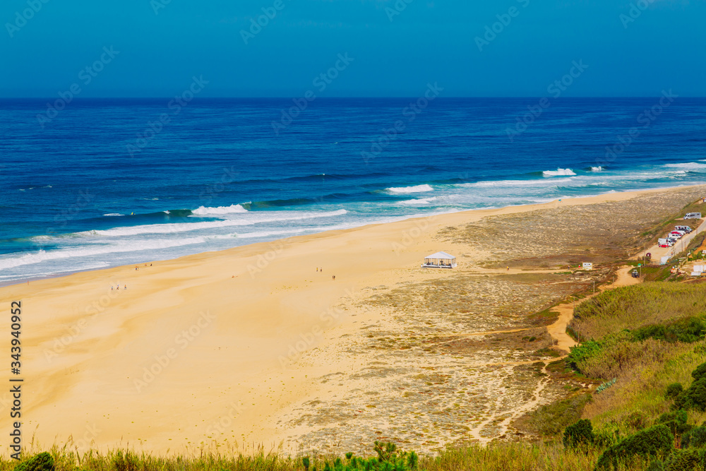View of sandy North beach and blue Atlantc Ocean in Nazare, Portugal
