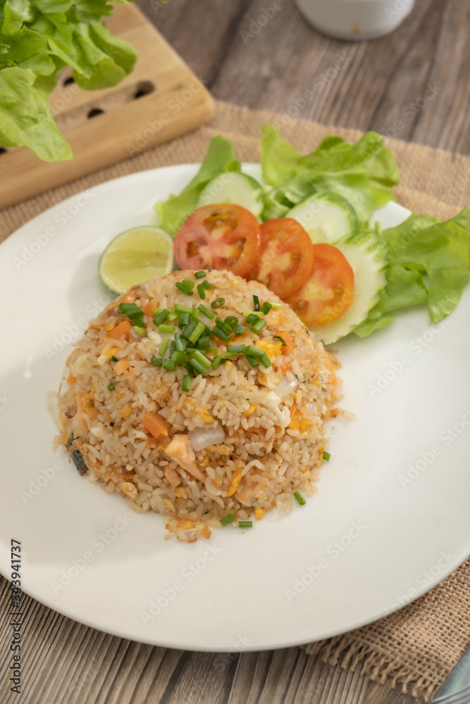 Fried rice with egg and grilled salmon on the white plate -Stock photo Fried rice with egg and grilled salmon on the white plate -Stock photo