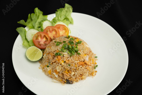 Fried rice with egg and grilled salmon on black background  -Stock photo