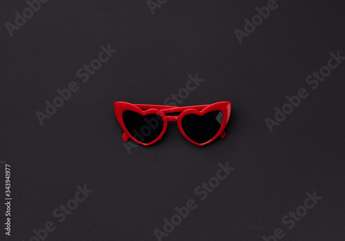 Flat lay top view minimal composition with sunglasses in heart shape
