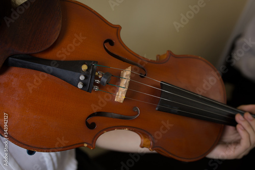 Girl playing the violin. Old violin close-up