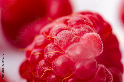 raspberries on a white saucer close up  macro photo