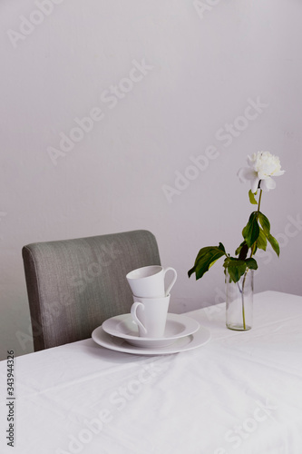 A white flower with white tableware, white tones