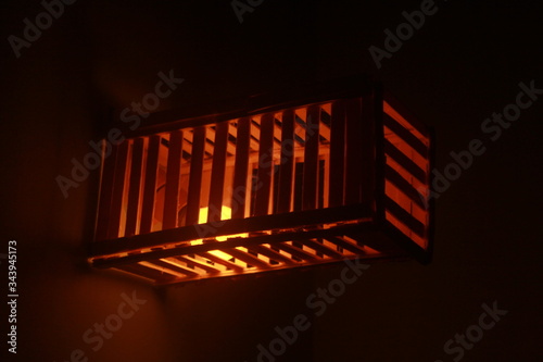 light in the wall. lamp design with matchsticks photo