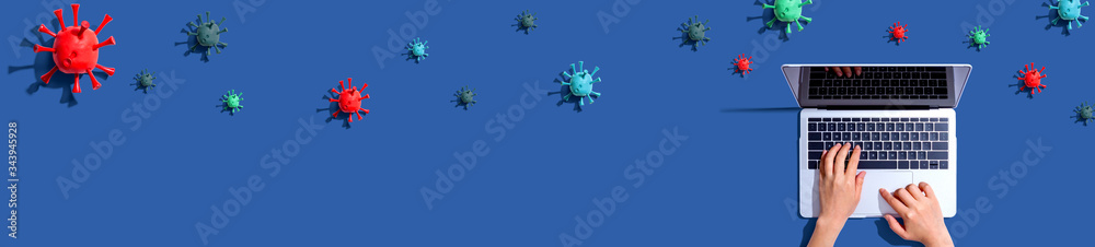 Laptop computer with epidemic influenza concept - overhead view Laptop computer with epidemic influenza concept - overhead view