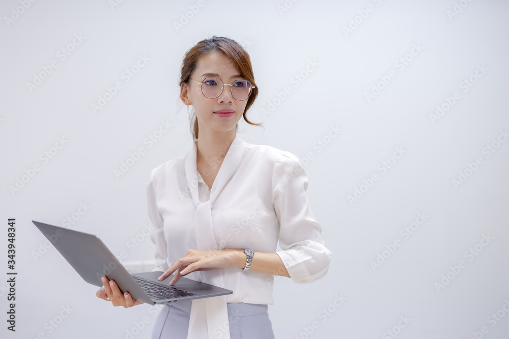 Portrait of a businesswoman holding a notebook and looking at something in a white background Portrait of a businesswoman holding a notebook and looking at something in a white background