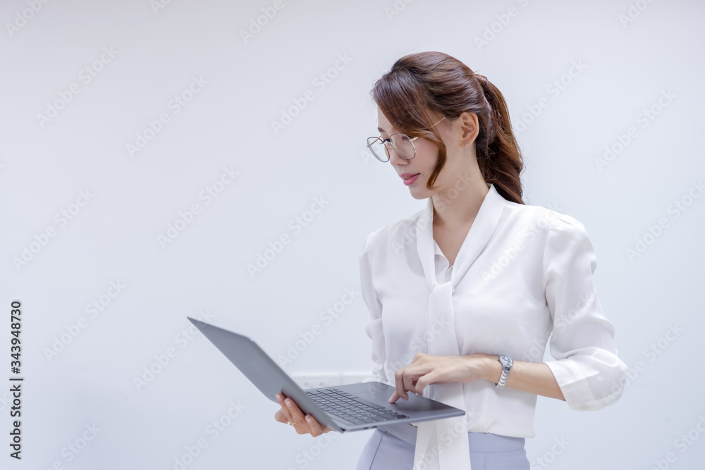 Portrait of business looking at laptop and workking in office. Young business colleagues discussing work in the office. Portrait of business looking at laptop and workking in office. Young business colleagues discussing work in the office.