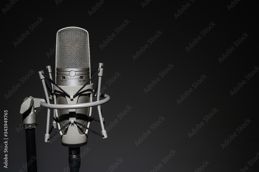 Professional, studio microphone on a black background. Is isolated..Can be used for audio, karaoke and music content.