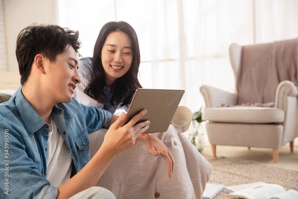 Young lovers watch tablets Young lovers watch tablets