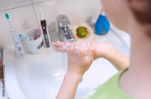 Boy washing his hands thoroughly