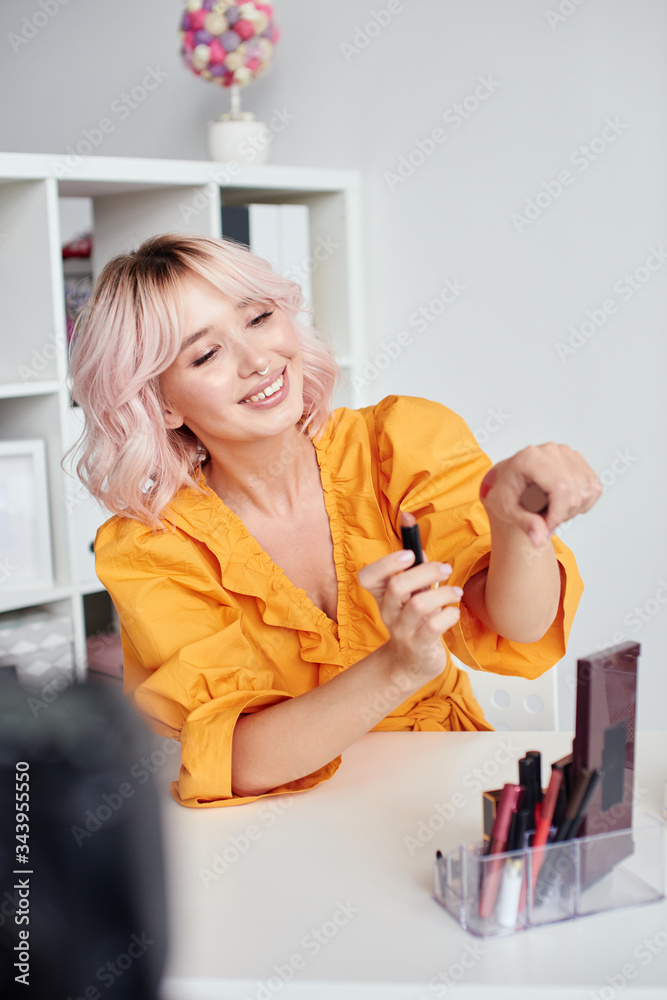 Pretty woman recording beauty video at home Pretty woman recording beauty video at home