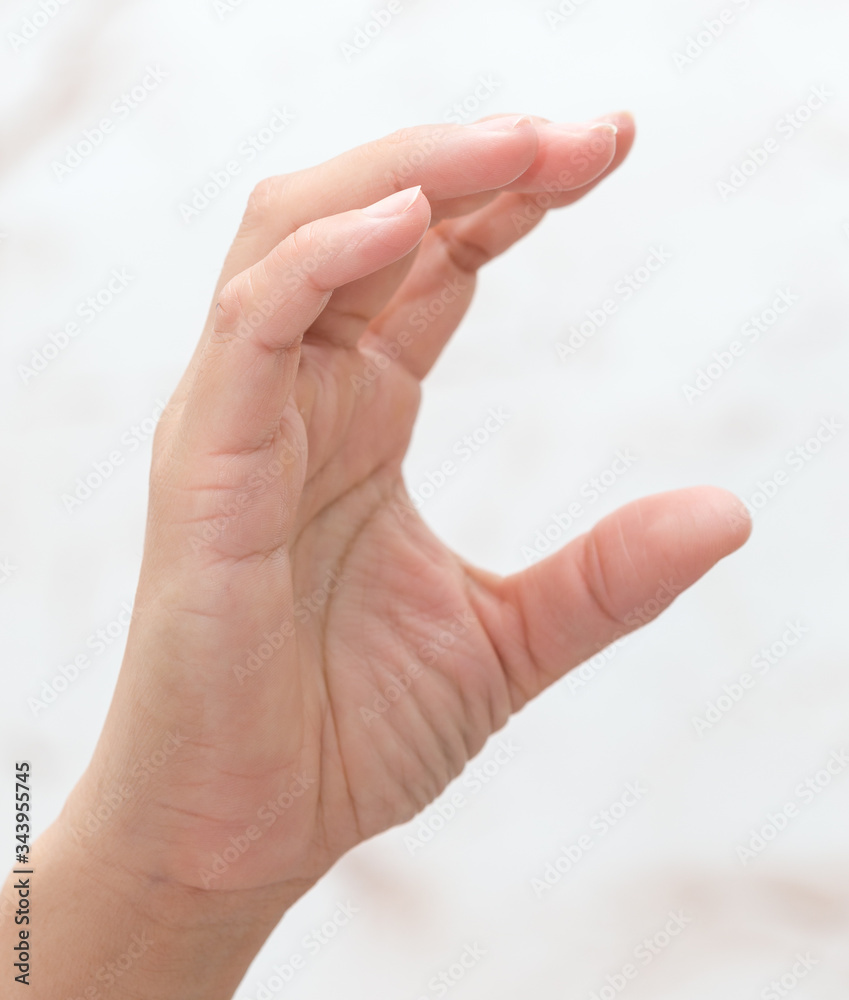 female hand wants to hold on a white background