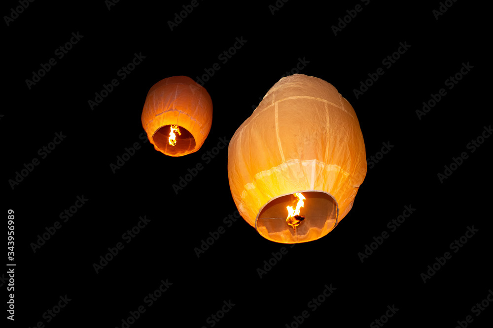 Colorful circle paper floating lanterns are flying to dark night skies