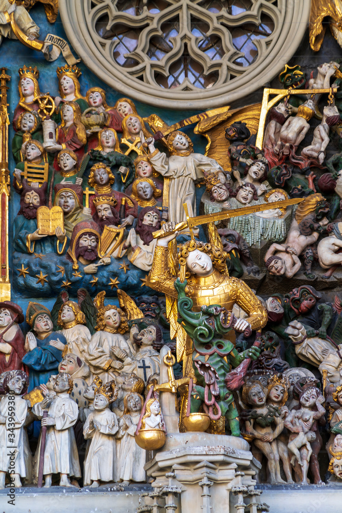 Fototapeta premium Close-up of Last Judgement stone carving (15th c.) above entrance of Minster cathedral, Bern
