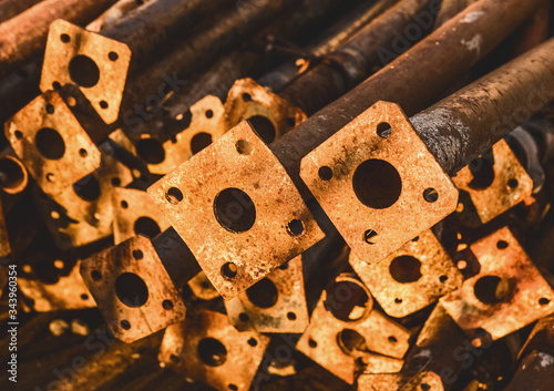 Pile of old, rusty temporary fencing pipes at a construction site