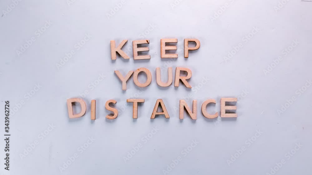 The word, keep your distance, made of dancing letters on a white background. The fight against coronavirus infection COVID-19. Matting inscription. The word, keep your distance, made of dancing letters on a white background. The fight against coronavirus infection COVID-19. Matting inscription.