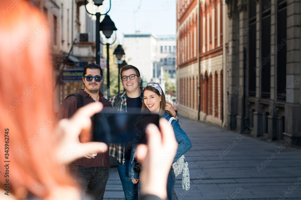 Fototapeta premium Group of millennial's sightseeing the city