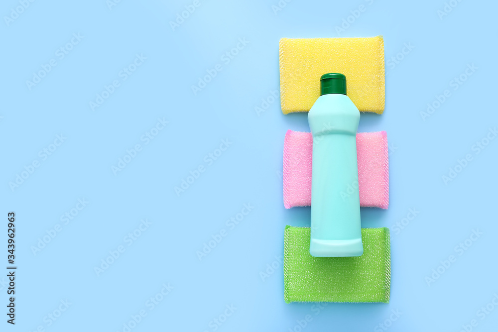 Colored kitchen sponges on blue background. Kitchen cleaning set