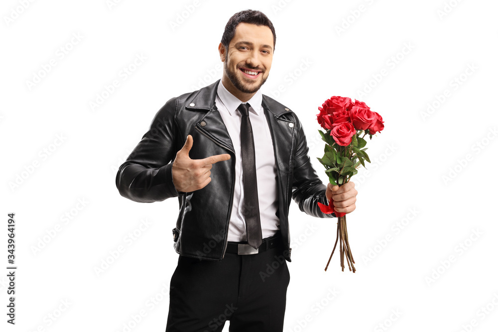 Handsome man in a leather jacket holding a bunch of roses and pointing Handsome man in a leather jacket holding a bunch of roses and pointing