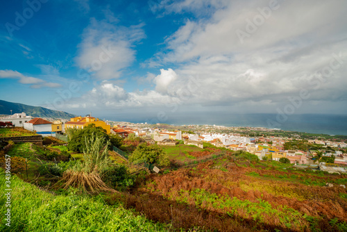 Village in Tenerife on the atlantic ocean with clouds and blue sky photo