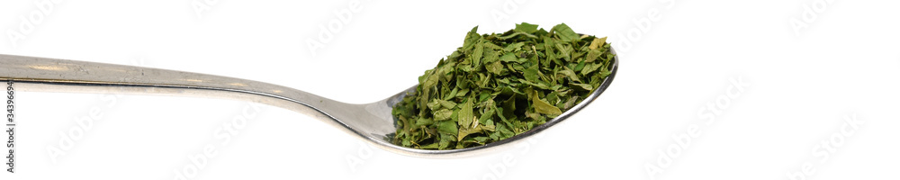 Teaspoon with dried parsley isolated on white background Teaspoon with dried parsley isolated on white background