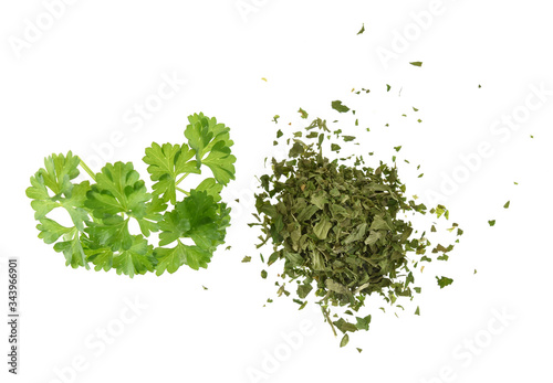 Pinch of fresh and dried parsley isolated on white background