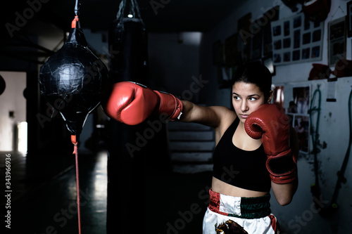 Young woman practicing boxing at gym