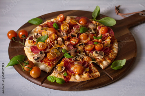 Tasty pizza and fries on wood serving board, white background. Horizontal image