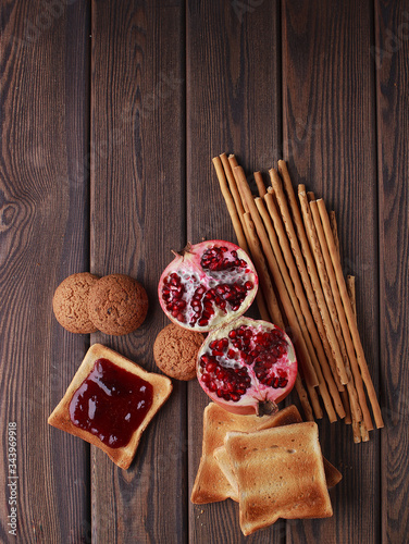 Different buns of fresh bread and spikelets of wheat on a brown vintage background photo