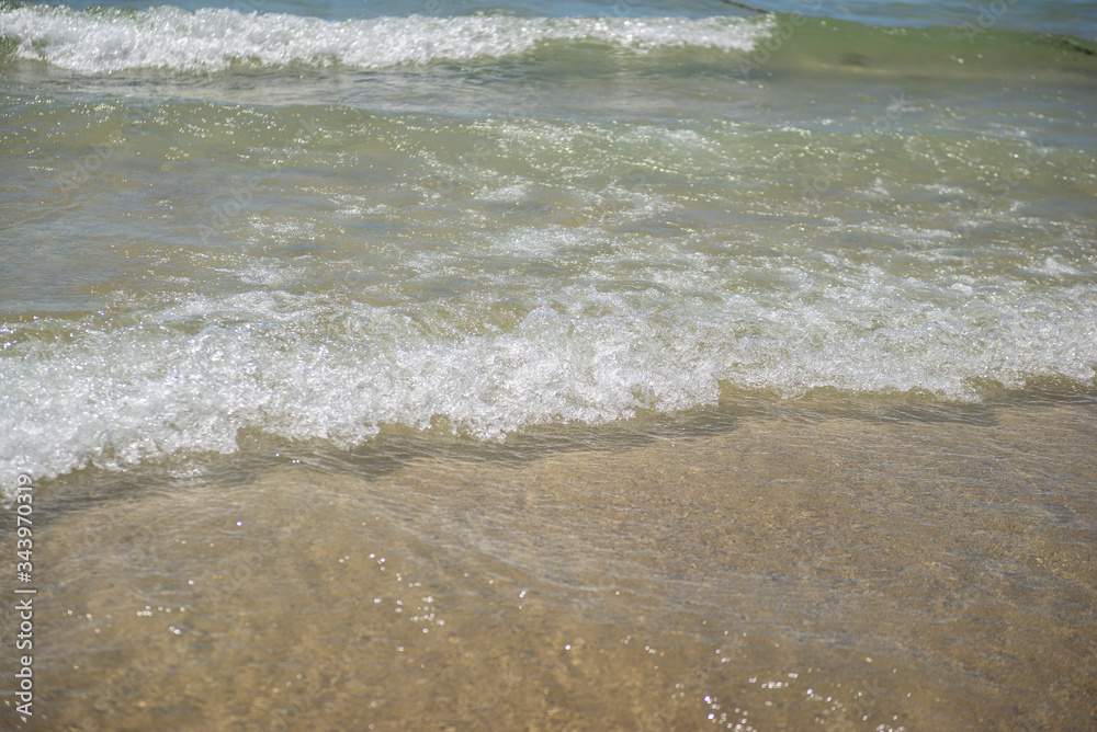 Small waves on the shore. Vacation and tranquility concept. wave water covering the beach sand. Small waves on the shore. Vacation and tranquility concept. wave water covering the beach sand.