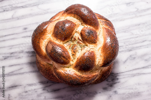 Braided Round Challah Bread Loaf with Poppy Seeds photo