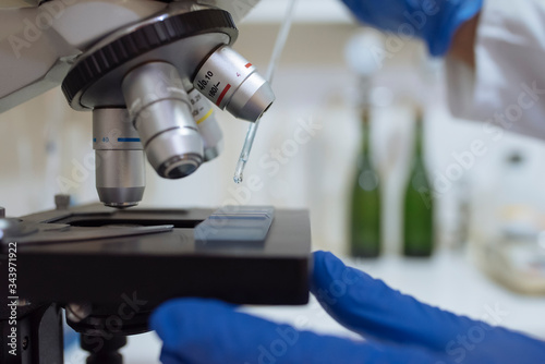 Close up of sample on microscope in winery laboratory.