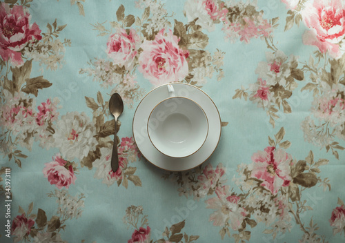 cup of tea and spoon on a flowered background