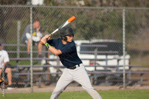Teen baseball player ready to swing in the batters box