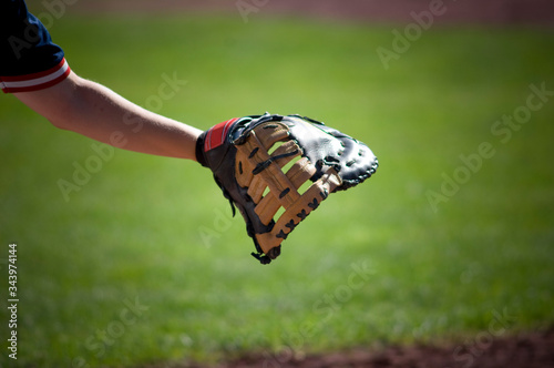 close-up of first baseman's glove reaching out photo