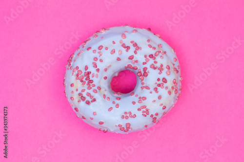Sweet blue donut on pink background. Dessert food