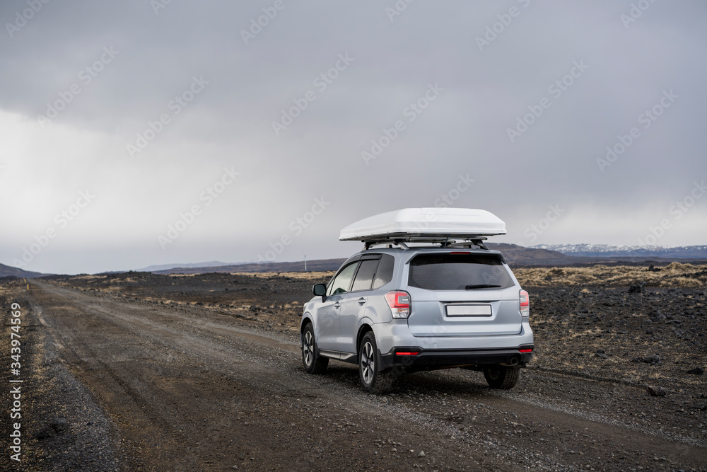 Car driving on gravel road in Iceland Car driving on gravel road in Iceland