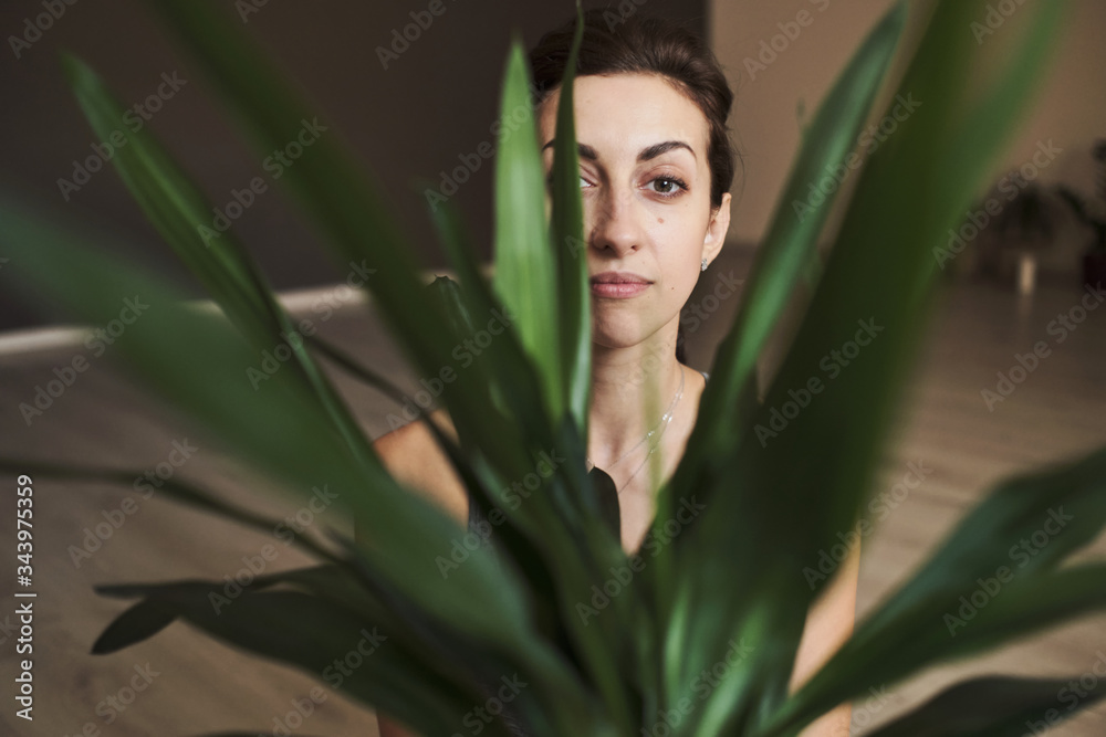 happy young woman 30 years old with flowers and home flowerpots happy young woman 30 years old with flowers and home flowerpots