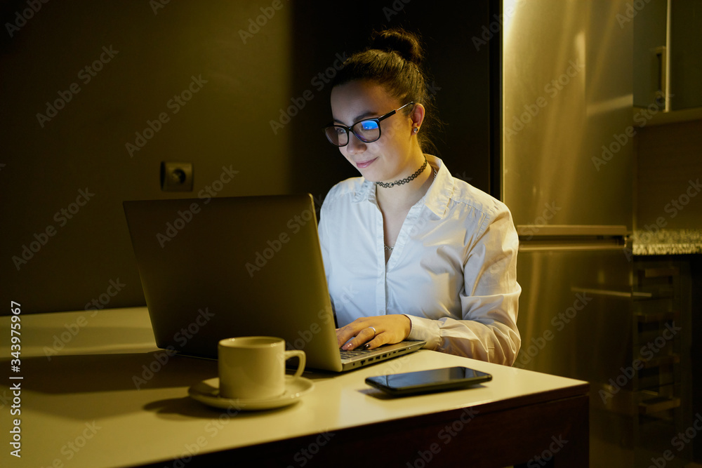 Young woman working with laptop in evening Young woman working with laptop in evening
