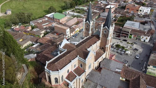 Typical Antioquia Village with Big Catedral Surrounded of Green Hills of Pastures and Mountains Aerial View in Belmira, Antioquia / Colombia photo