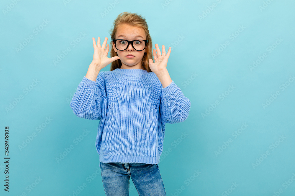 attractive european girl with glasses on a light blue wall with copyspace with copyspace