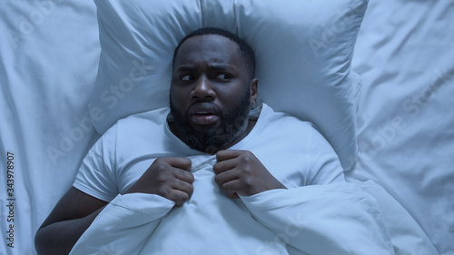 Nervous man seeing bad dream during sleeping, cant waking up, stressful life photo